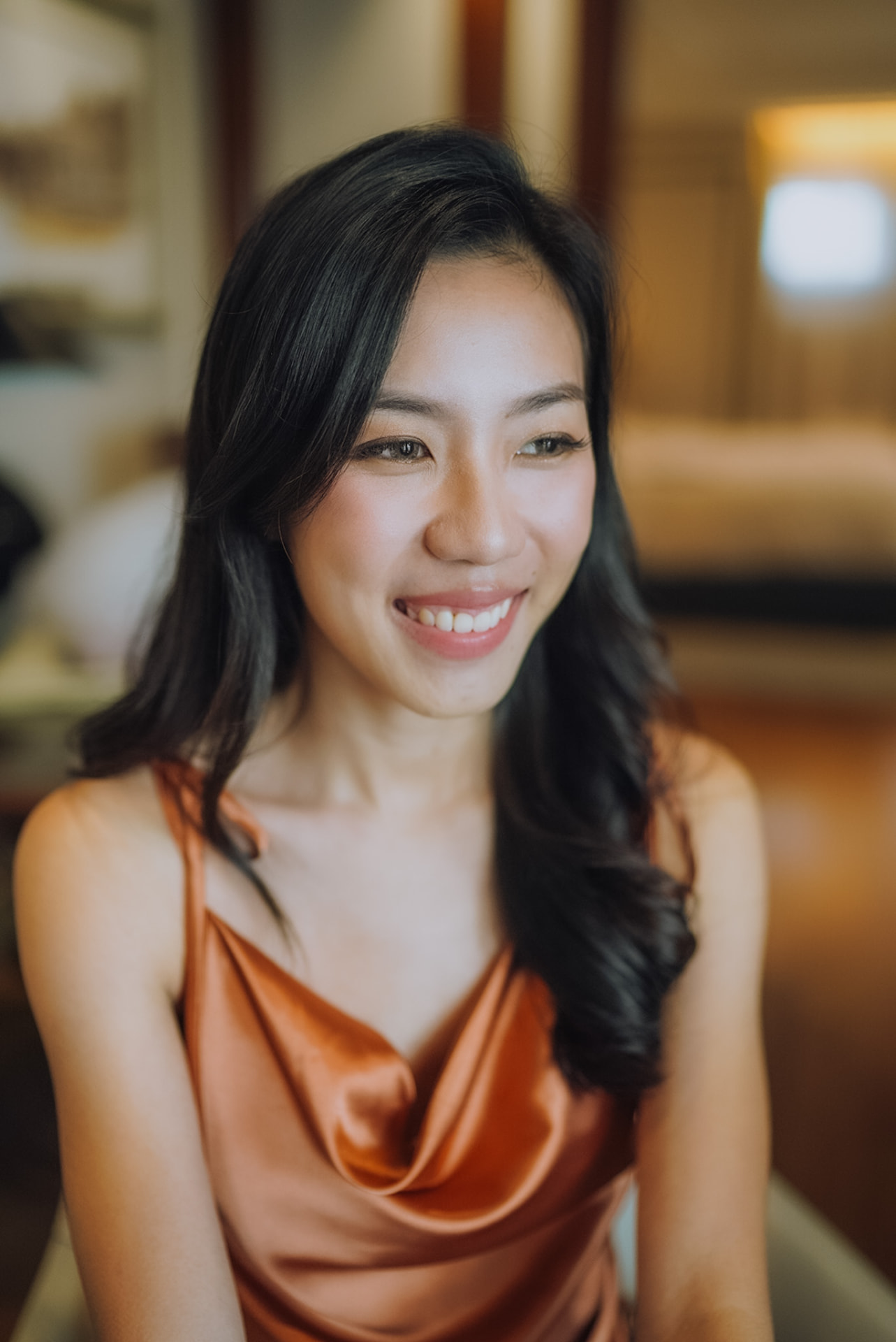 Bride in a satin slip dress, soft waves and a warm smile