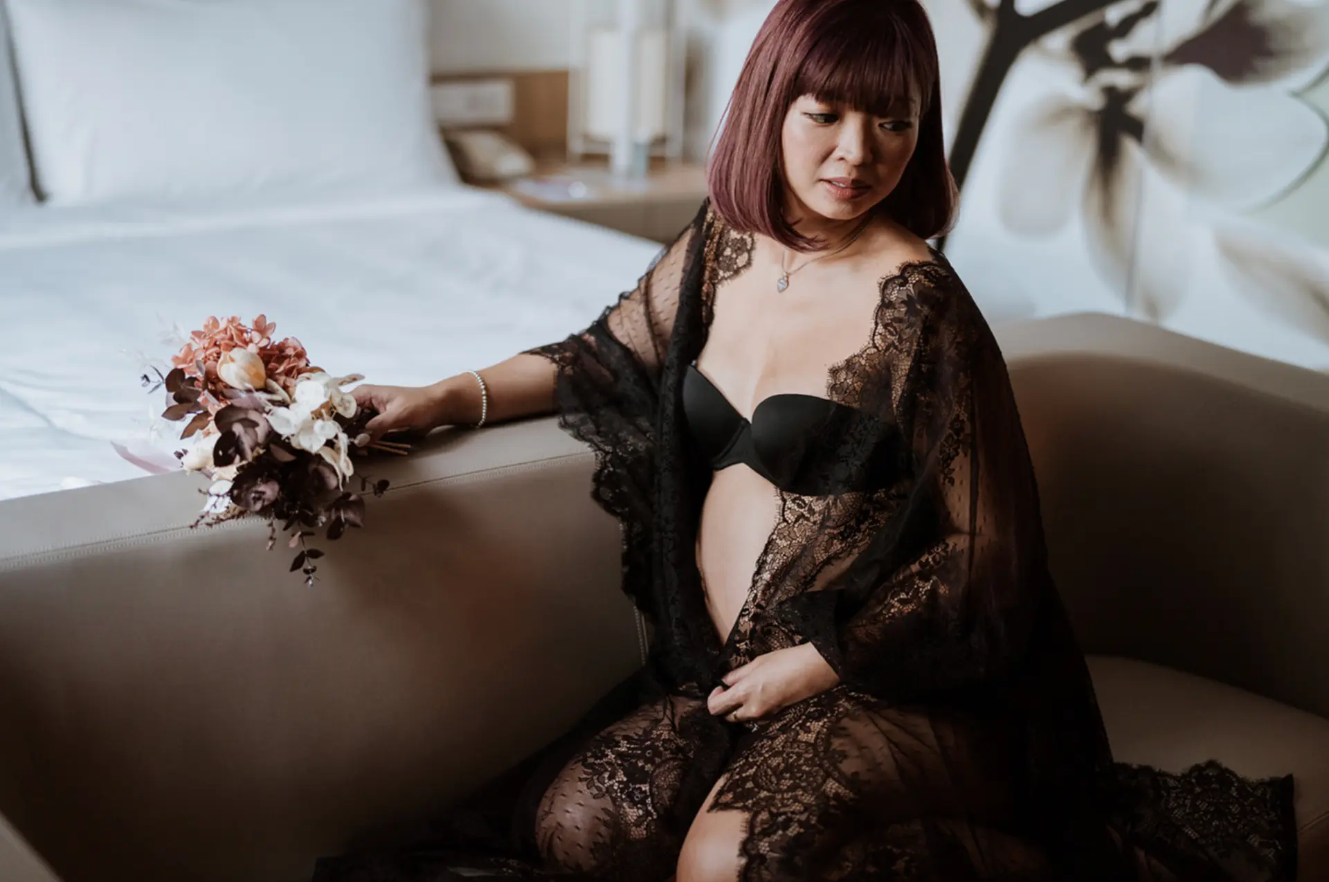 Phillane seated by the window in black lace