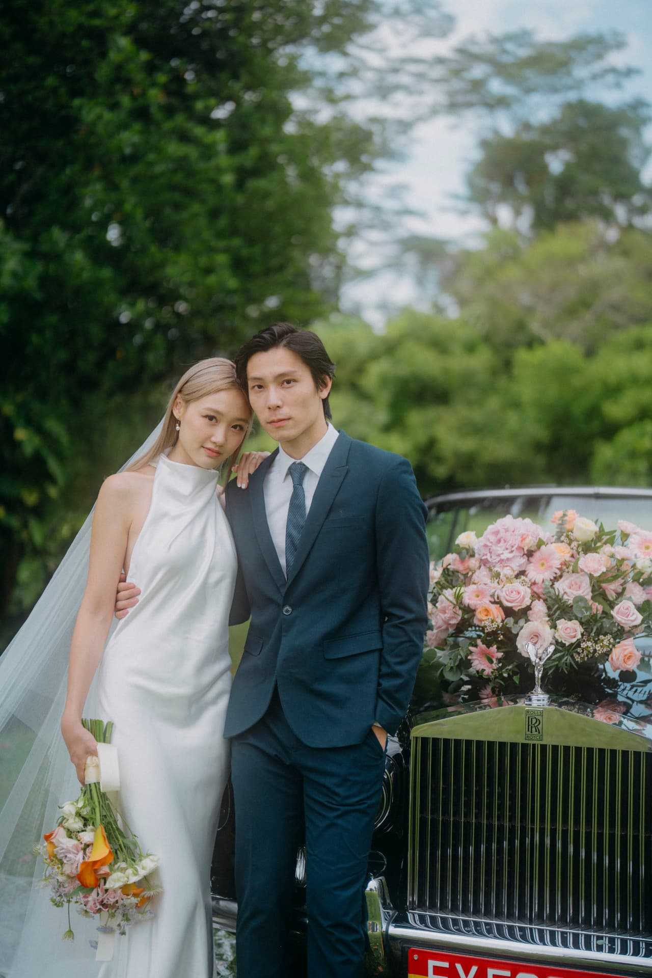 Tim & Denise — couple leaning together beside the vintage car