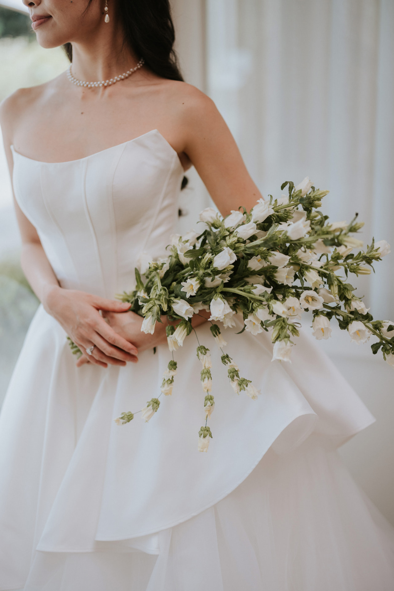 Cloud Dancer — the bride's bodice and pearls with the bellflower bouquet