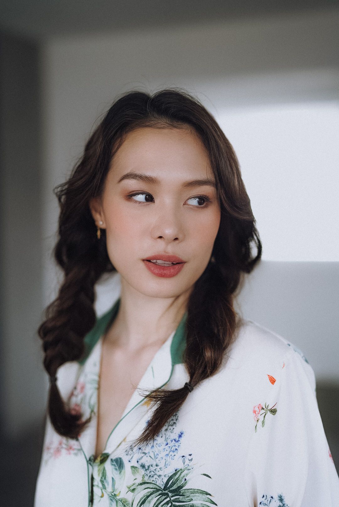 Cala Barrett — glancing to the side, braids loosely tied