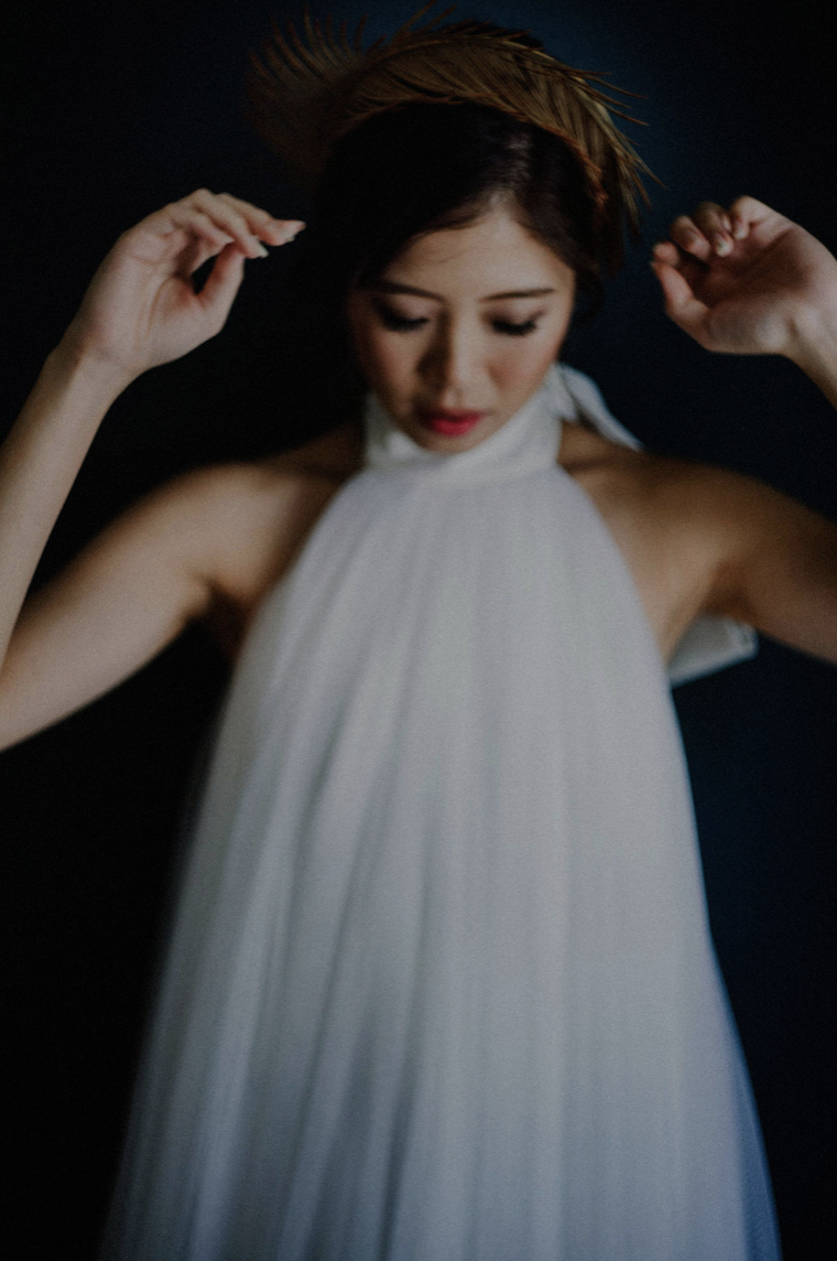 Ophelia — lifting the golden headpiece in the white halter gown