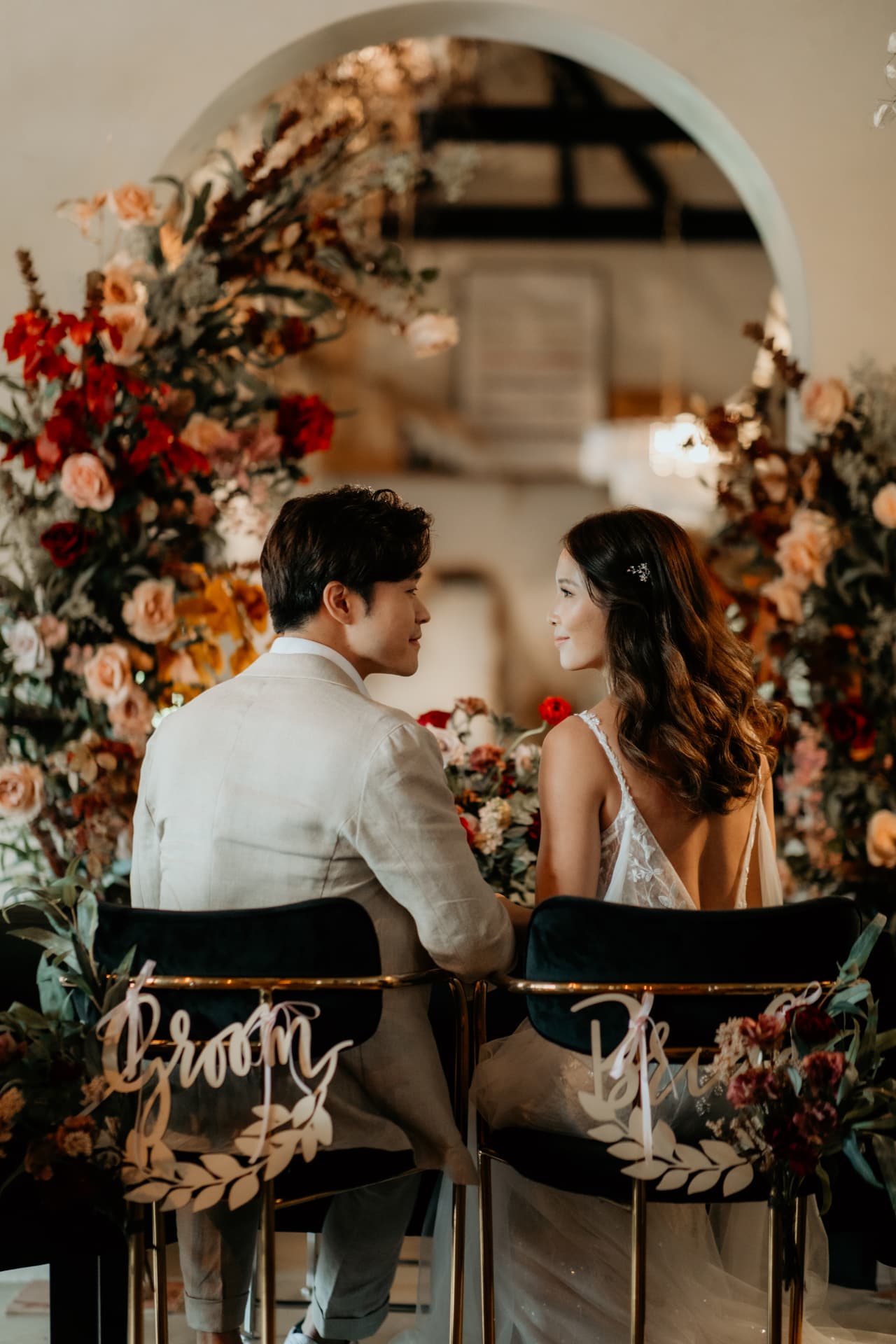 Benzo & Stacey seated on the groom and bride chairs